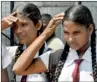  ??  ?? Thrisha Nadeera (left) suffering from constant headaches due to the scorching sun. Pix by Susantha Liyanawatt­e