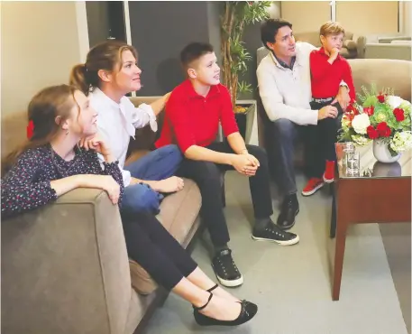  ?? STEPHANE MAHE/REUTERS ?? Justin Trudeau, with Sophie Gregoire Trudeau, children Xavier, Hadrien and Ella-Grace, follows the results in Montreal.