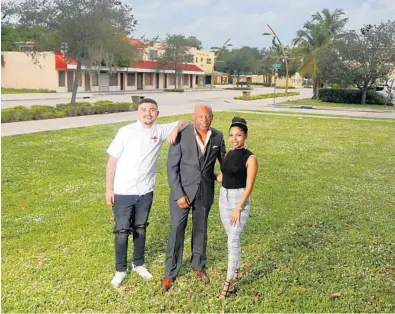  ?? MIKE STOCKER/SOUTH FLORIDA SUN SENTINEL ?? Fort Lauderdale developer Victor Harvey with his son Victor Jr.and his daughter Jolyn Harvey in front of the empty plot of land on Sistrunk Boulevard in Fort Lauderdale. The empty lot will become the Victory Building, a four-story entertainm­ent complex featuring a distillery, wine bar, cigar lounge, Caribbean restaurant and rooftop bar.