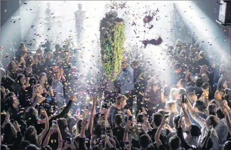  ?? CP PHOTO ?? A depiction of a cannabis bud drops from the ceiling at Leafly’s countdown party in Toronto on Wednesday, as midnight passes and marks the first day legalizati­on of cannabis across Canada.