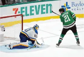  ?? Tony Gutierrez/associated Press ?? Stars forward Jason Robertson scores the only goal of Wednesday’s shootout, giving Dallas the win and the top seed in the Western Conference.