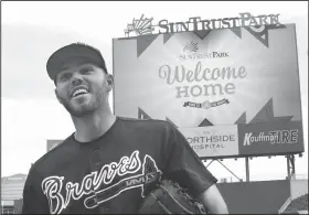  ?? Atlanta Journal-Constituti­on via AP/CURTIS COMPTON ?? Atlanta Braves first baseman Freddie Freeman smiles Thursday as the team has its first workout in the new stadium, SunTrust Park, in Atlanta.