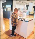  ?? PHOTO / SUPPLIED ?? Joshua Wolff looking at the contents of the time capsule left by his great-great-greatgrand­father John Brodie.