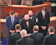  ?? (AP/Erin Scott) ?? Republican members of the House of Representa­tives from Louisiana, including Rep. Mike Johnson, House Minority Whip Steve Scalise, Rep. Clay Higgins and Rep. Garret Graves, lead the House in a moment of silence Sunday for Louisiana Rep.-elect Luke Letlow, who recently died from covid-19.