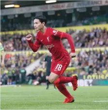  ?? ?? Liverpool’s Japan forward Takumi Minamino celebrates scoring their first goal against Norwich City. — Reuters