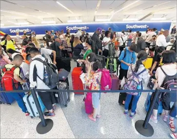  ?? Al Seib Los Angeles Times ?? THE SPEED of LAX’s free Wi-Fi ranks 12th among the nation’s 20 largest airports, a study by tech firm Ookla found. Above, passengers wait in line at the Southwest Airlines ticket counter in July.