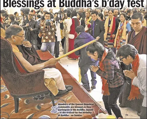  ??  ?? Members of the Queens Nepalese community are blessed as they participat­e in the Buddha Jayanti – or the festival for the birthday of Buddha – on Sunday.