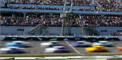  ?? SEAN GARDNER, GETTY IMAGES ?? Cars whip by the start-finish line at Daytona Internatio­nal Speedway during Sunday’s 59th Daytona 500.