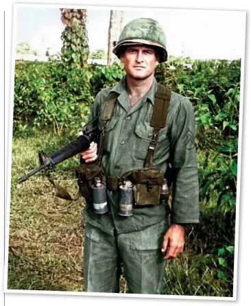  ??  ?? An American NCO illustrate­s typical M1956 webbing in service conditions with smoke and fragmentat­ion grenades attached to the outside of the ammunition pouches