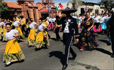  ?? RECORDER PHOTO BY ESTHER AVILA ?? Walking alongside a large group of student folkloric dancers from Portervill­e schools, a Charro waves Saturday at spectators along the Cinco de Mayo parade route.