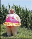  ?? PETER DEJONG — THE ASSOCIATED PRESS ?? A spectator in an inflatable costume wait for the riders during the eighteenth stage of the Tour de France cycling race over 171 kilometers (106.3 miles) with start in Trie-sur-Baise and finish in Pau, France, Thursday, July 26, 2018.