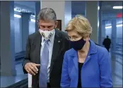  ?? PATRICK SEMANSKY — THE ASSOCIATED PRESS ?? Sen. Joe Manchin, D-W.Va., left, speaks with Sen. Elizabeth Warren, D-Mass., on Capitol Hill in Washington on Wednesday.