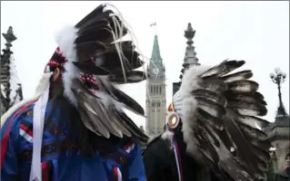  ?? ADRIAN WYLD, THE CANADIAN PRESS ?? Aboriginal chiefs stand in support in Ottawa at the main gate to Parliament Hill during a protest Friday.