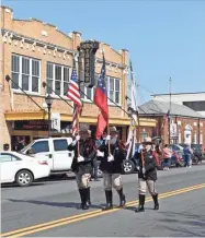  ?? Blake Silvers ?? The Gordon County Sheriff’s Office color guard marches past the GEM Theatre as Saturday’s 9/11 Patriots Day Parade makes its way through downtown.