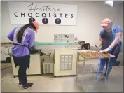  ??  ?? Above, Kylee Knott, left, and Brittany Stewart make sea salt caramel chocolates at the “enrobing” machine. The machine enrobes solid fillings in chocolate. Below, handmade gelato by the Gelato Kings in Long Island, N.Y., has proven popular at Heritage...