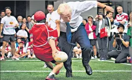  ?? AP/FILE ?? THE GREAT FALL: Boris Johnson takes part in a Street Rugby tournament in a Tokyo.