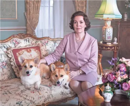  ?? PHOTOS BY SOPHIE MUTEVELIAN/NETFLIX ?? Olivia Colman as Queen Elizabeth II with her famous corgis.