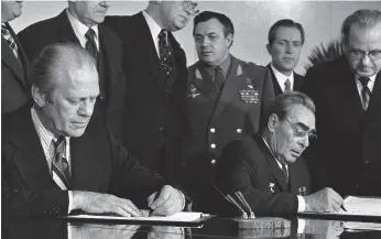  ?? Gerald R. Ford Library 1974 ?? President Gerald Ford and Soviet General Secretary Leonid Brezhnev sign a joint communique after 1974 talks on the limitation of strategic offensive arms.