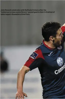  ??  ?? John Russell celebrates with Raffaele Cretaro after the Tubbercurr­y man scores Rovers’ second goal in their 3- 0 defeat of table toppers Dundalk in Oriel Park.