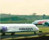  ?? LUCY PEMONI/AP ?? An Hawaiian Airlines plane taxis at Kahalui, Hawaii, on the island of Maui, in 2005. Alaska Air Group said Sunday that it agreed to buy Hawaiian Airlines.