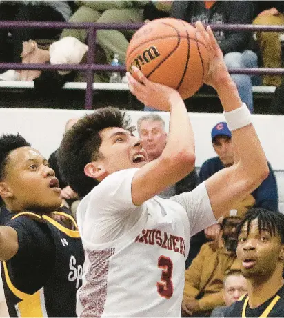  ?? JOHN SMIERCIAK/DAILY SOUTHTOWN ?? Brother Rice’s Marcos Gonzales goes up for a layup as Marian Catholic’s Adam Shorter defends during Wednesday’s Class 3A Thornton Sectional semifinal in Harvey.