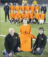  ?? Photograph: Iain Ferguson, The Write Image Photograph: Iain Ferguson, The Write Image ?? Davy Duncan and Helen Smith of Lochaber Embroidery and Printing (LEAP) presented new strips to Fort William FC U-17 team captain, Fraser Gray. Training for the team takes place every Friday evening from 6.30pm on the all weather pitch at Lochaber High...