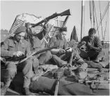  ?? ?? ■ Men of The Green Howards prepare their kit just before embarking for the Normandy landing of 6 June 1944.