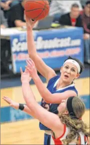  ?? JIM WITMER / STAFF ?? Greeneview’s Ashton Lovely, who finished with 18 points, goes to the hoop against Versailles’ Katie Heckman in the D-III Regional final at Springfiel­d High School on Saturday. Versailles reached its sixth state tourney.