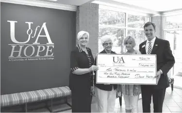  ?? Associated Press ?? From left, family members of the late Private Van Ryan Marcum, Dolly Henley (aunt), Adell Campbell (grandmothe­r) and Gaye Marcum (mother), present a $10,000 check to University of Arkansas Community College at Hope-Texarkana Chancellor Chris Thomason...