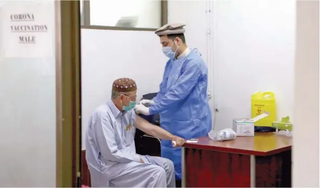  ?? Associated Press ?? ↑
A man receives the second shot of the Sinopharm vaccine at a vaccinatio­n centre in Peshawar on Wednesday.