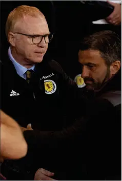  ??  ?? Left: Alex McLeish with Albania manager Cristian Panucci at full-time.Right: McLeish celebrates with assistant manager Peter Grant