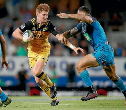  ?? PHOTO: GETTY IMAGES ?? Jordie Barrett tries to avoid the tackle Sonny Bill Williams during the Super Rugby match between the Blues and the Hurrricane­s on Saturday.