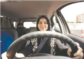  ?? THE ASSOCIATED PRESS ?? A student at the female-only campus of Effat University sits for the first time in the driver’s seat Tuesday during training sponsored by Ford Motor Co. in Jiddah, Saudi Arabia.