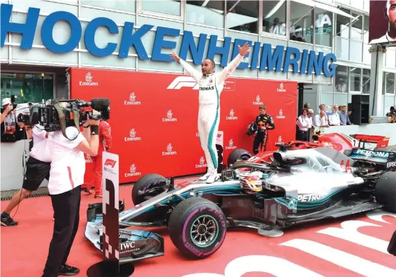  ??  ?? Mercedes driver Lewis Hamilton of Britain celebrates after winning the German F1 Grand Prix Photo: AP