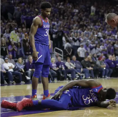  ?? AP ?? Kansas center Udoka Azubuike lands with an injured ankle during the first half against Kansas State.