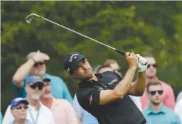  ?? Associated Press ?? n Kevin Kisner watches his tee shot on the 13th hole during the second round of the PGA Championsh­ip golf tournament Friday at the Quail Hollow Club in Charlotte, N.C.