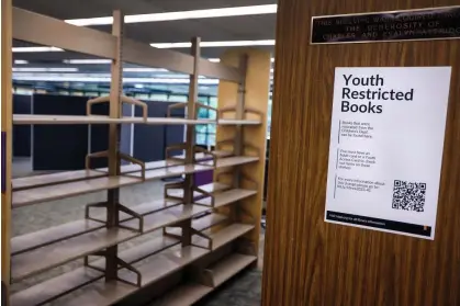  ?? ?? Two new rows of shelves dedicated to ‘youth restricted books’ sit mostly empty at the Huntington Beach central library in Huntington Beach, California, on 21 February 2024. Photograph: Rick Loomis for The Washington Post via Getty Images