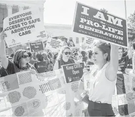  ?? Pete Marovich / Getty Images ?? In a 5-3 decision, the U.S. Supreme Court struck down one of the nation’s toughest restrictio­ns on abortion, a Texas law that women’s groups said would have forced more than three-quarters of the state’s clinics to close.