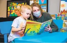  ?? JARROD VALLIERE U-T ?? Charlene Walker reads to Grayson Magnuson. She and husband, Dave, donated $100,000 to Home of Guiding Hands to help parents.