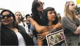  ?? Dorothy Edwards / The Chronicle 2015 ?? Above: Denise Benavides holds Jessica Sabogal at a rally in S.F. Left: Sabogal’s painting “Women Are Perfect.”
