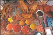  ??  ?? A Hindu priest prepares vermilion paste for pilgrims.