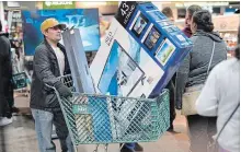  ?? NATI HARNIK THE ASSOCIATED PRESS ?? Black Friday shoppers wait in line to check out at the Nebraska Furniture Mart store in Omaha, Neb.