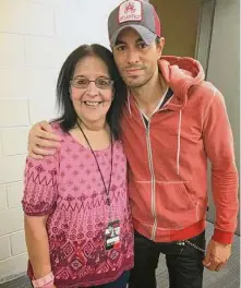  ?? Joey Guerra/Staff ?? Mom gets a photo with Enrique Iglesias, one of the many she took with some of the top entertaine­rs in the world.