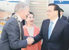  ??  ?? Chinese Premier Li Keqiang reacts as he is greeted by Auckland Mayor Phil Goff and Consul General Xu Erwen (center) after arriving in Auckland, New Zealand, March 27. — Reuters photo