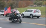  ??  ?? A motorcycli­st in a Santa hat participat­es in the 20th annual Toys for Tots Benefit Ride on Sunday in Brunswick.