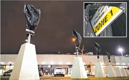  ?? STAFF PHOTOS BY CHRISTOPHE­R EVANS ?? RIDE FOR HIRE HERE: Plastic covers all but one Active Pick-Up AppRide signs, inset, in a lot between Terminals C and E at Logan Internatio­nal Airport yesterday, above. Lyft will begin picking up passengers here on Feb. 1.