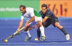  ?? AFP ?? Pakistan’s Rashid Mehmoud (left) gets past Malaysia’s Tengku Ahmad Tajuddin in Jakarta on Sunday.