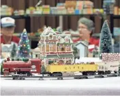  ?? ?? Art and Janet Lofton of Columbus watch the crowd from their Christmas-themed layout during the Buckeye Model Train Show.