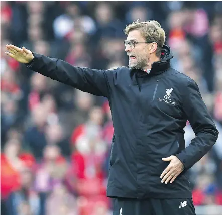  ?? — GETTY IMAGES ?? Liverpool coach Jurgen Klopp directs his team in their English FA Cup third-round match against Plymouth in Liverpool Sunday. Klopp took some heat for inserting 10 new players into his lineup in what proved to be a scoreless tie, meaning the teams will...