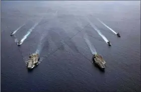  ?? U.S. NAVY VIA AP, FILE ?? In this photo provided by U.S. Navy, the USS Ronald Reagan (CVN 76) and USS Nimitz (CVN 68) Carrier Strike Groups steam move in formation in the South China Sea in 2020. The Nimitz aircraft carrier strike group performed drills Sunday amid tensions with China over the recent spy balloon drama.